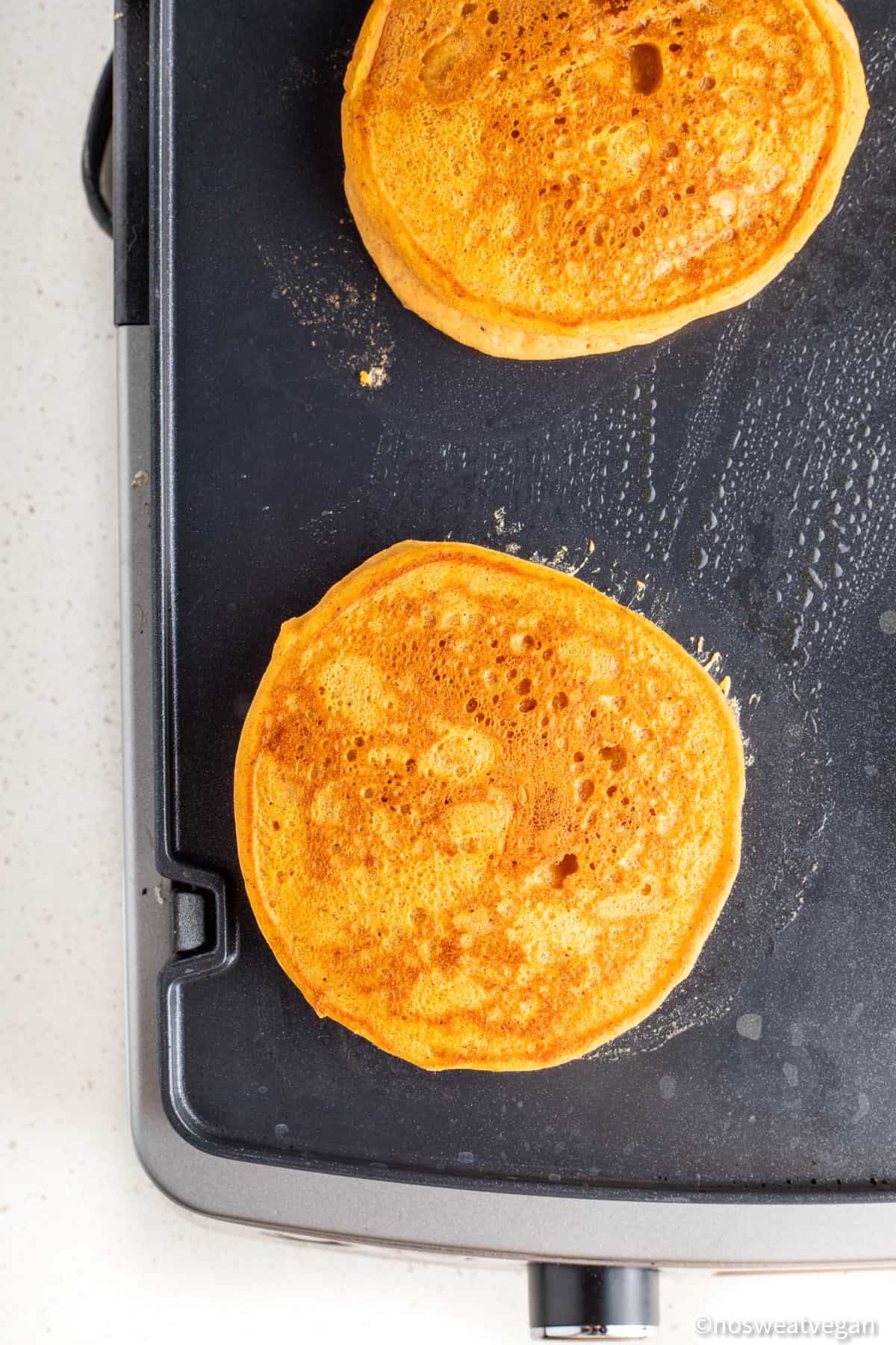 Vegan sweet potato pancakes on a skillet.