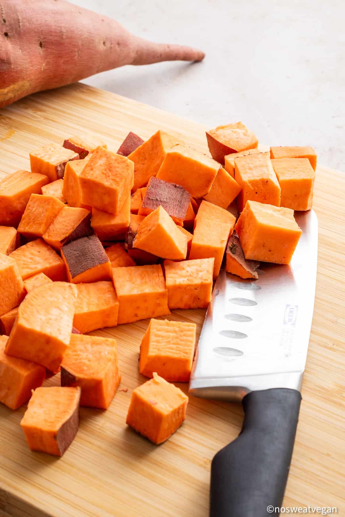 Cubed sweet potato on a cutting board.