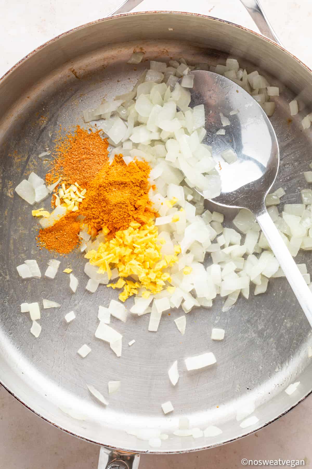Onions and seasoning in a skillet.