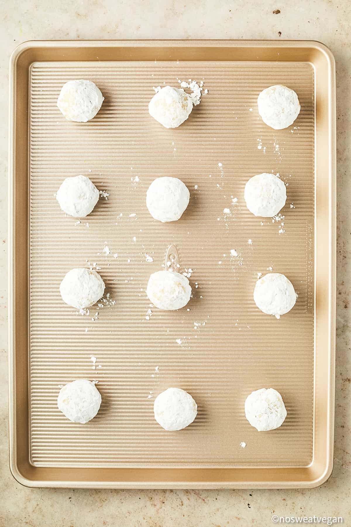 Vegan lemon cookies uncooked on a baking sheet.