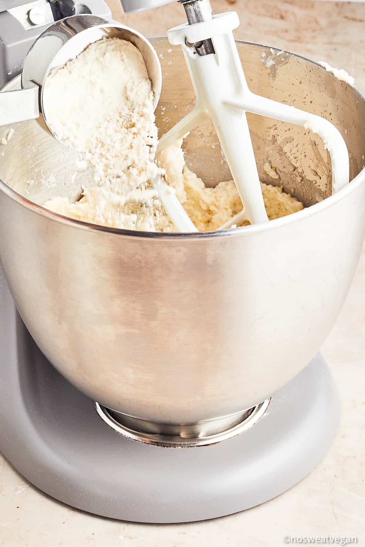 Adding flour to the lemon cookie dough.