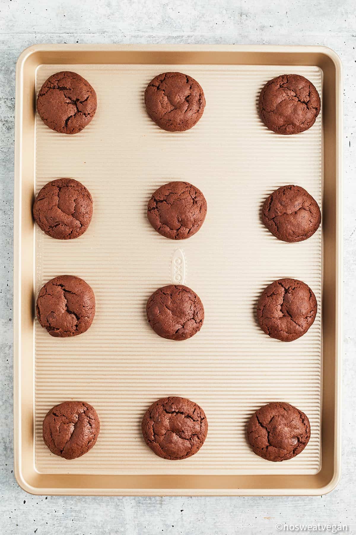 Vegan double chocolate chip cookies baked on a baking sheet.