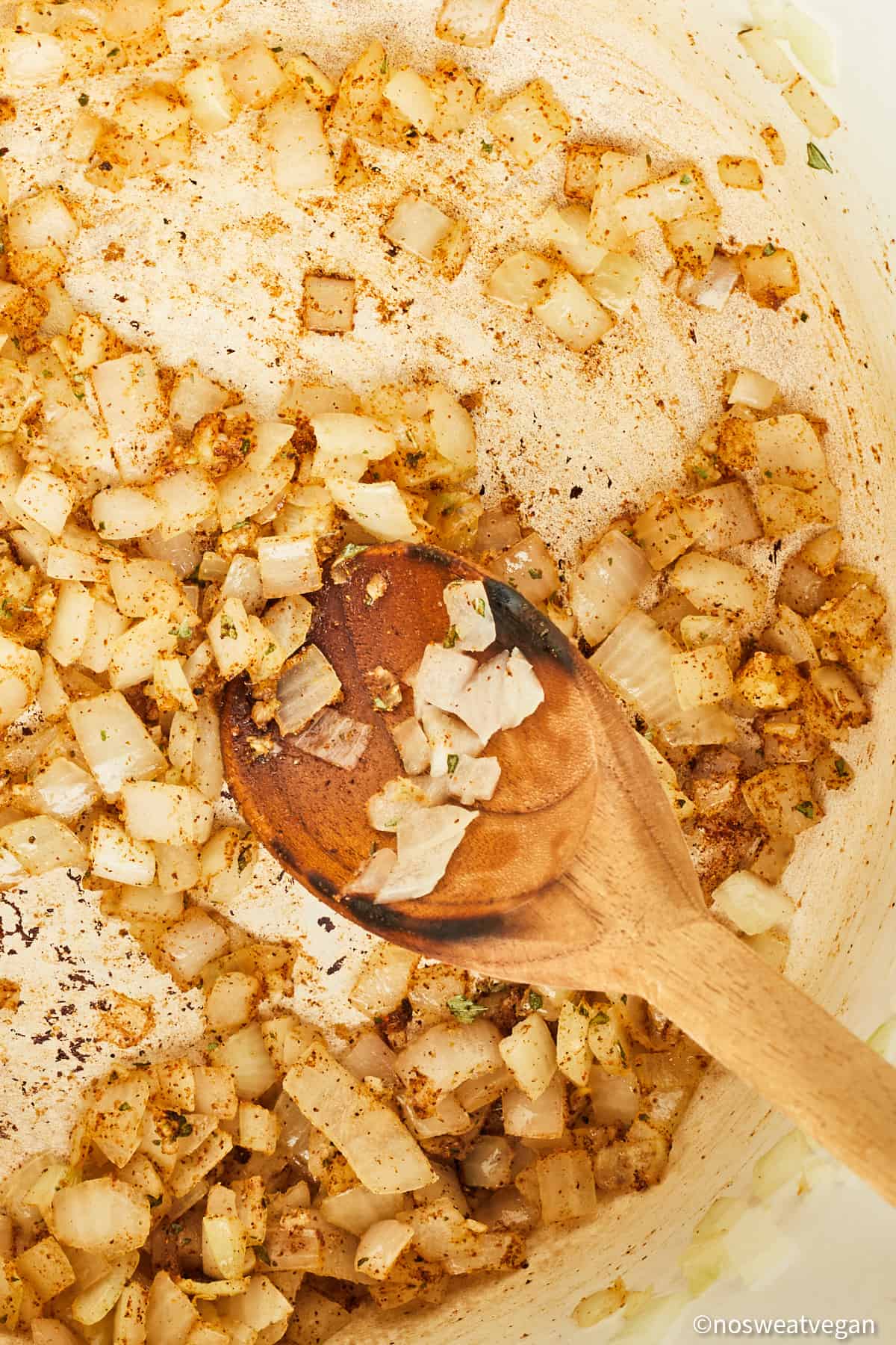 Onions and spices cooking in a pot.