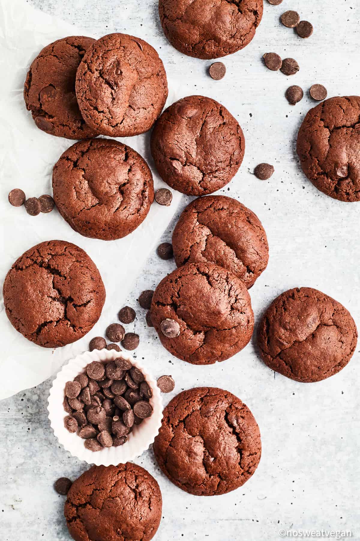 Vegan double chocolate cookies on a white surface.