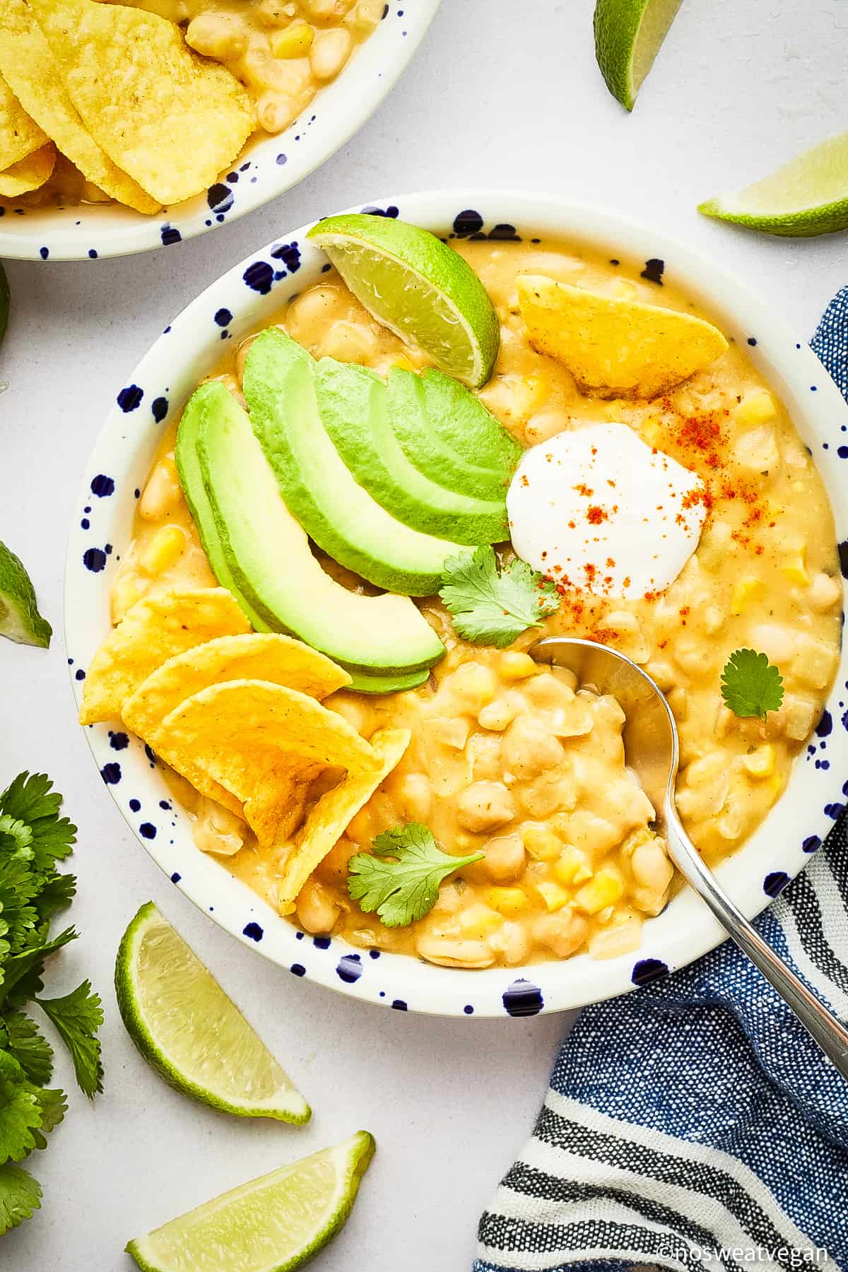 Vegan white bean chili in a bowl with toppings.