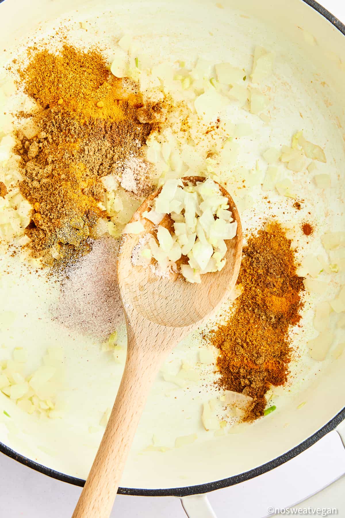 Adding spices to curry.