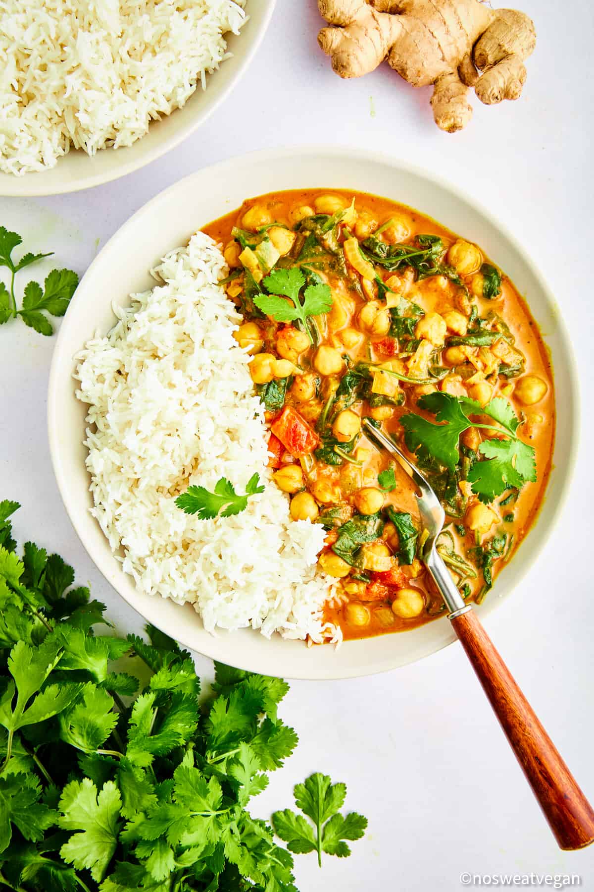 Bowl of spinach and chickpea curry with rice.
