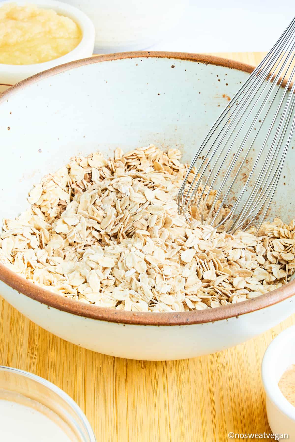 Dry ingredients in a bowl with a whisk.