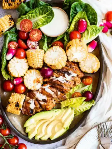 Peri-peri seitan chicken on a plate with veggies.