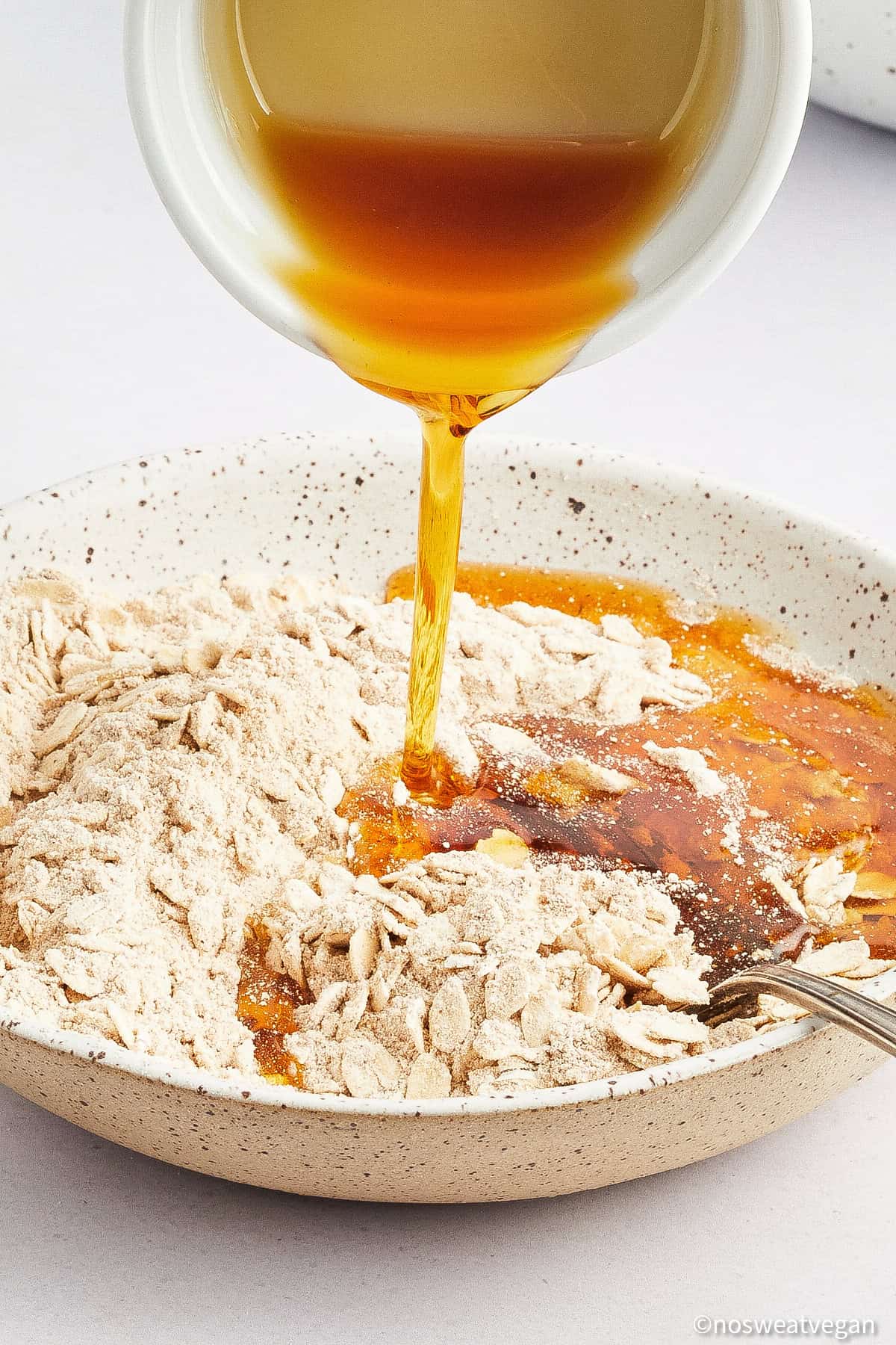 Adding maple syrup to the streusel topping.