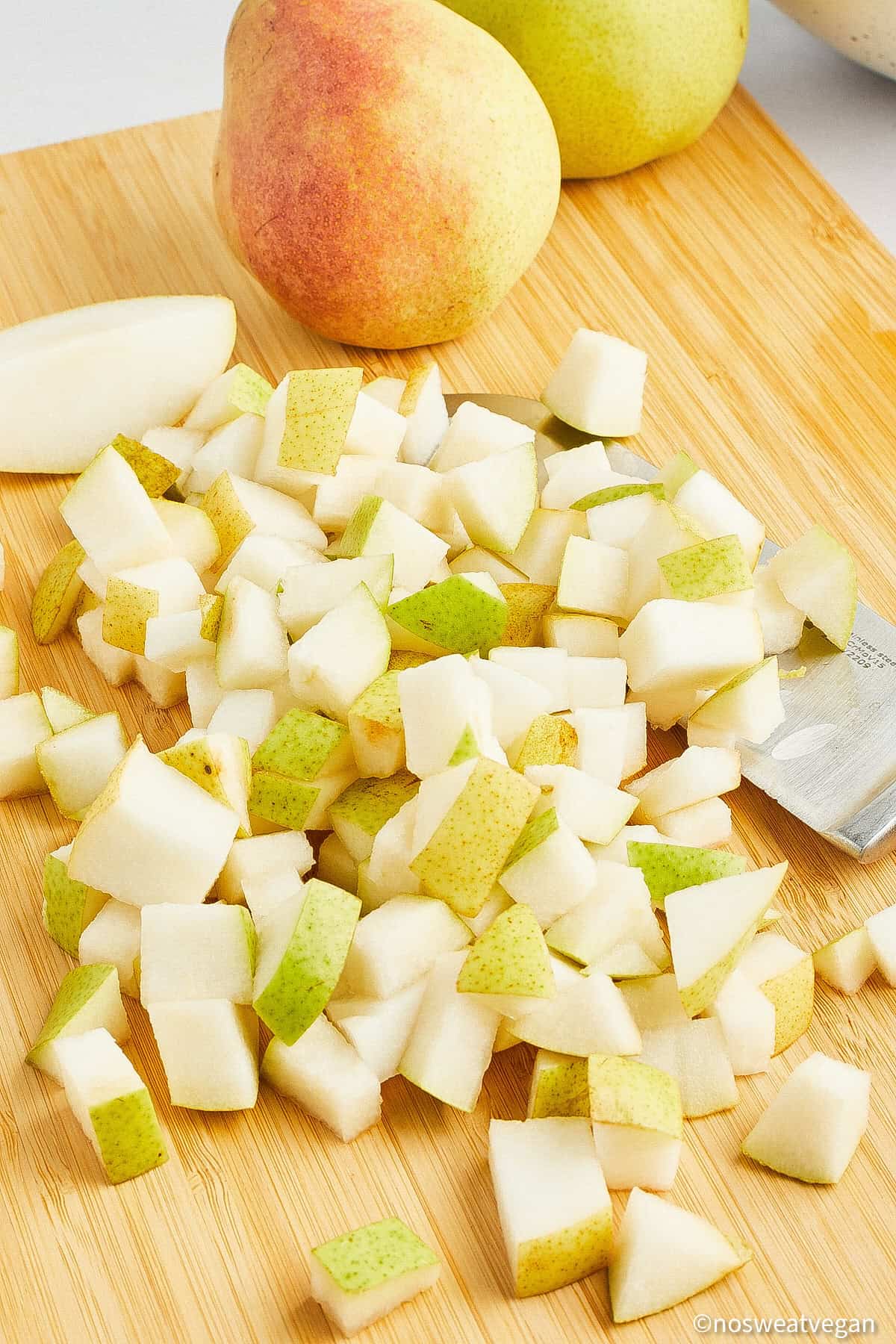 Cubed pears on a cutting board.