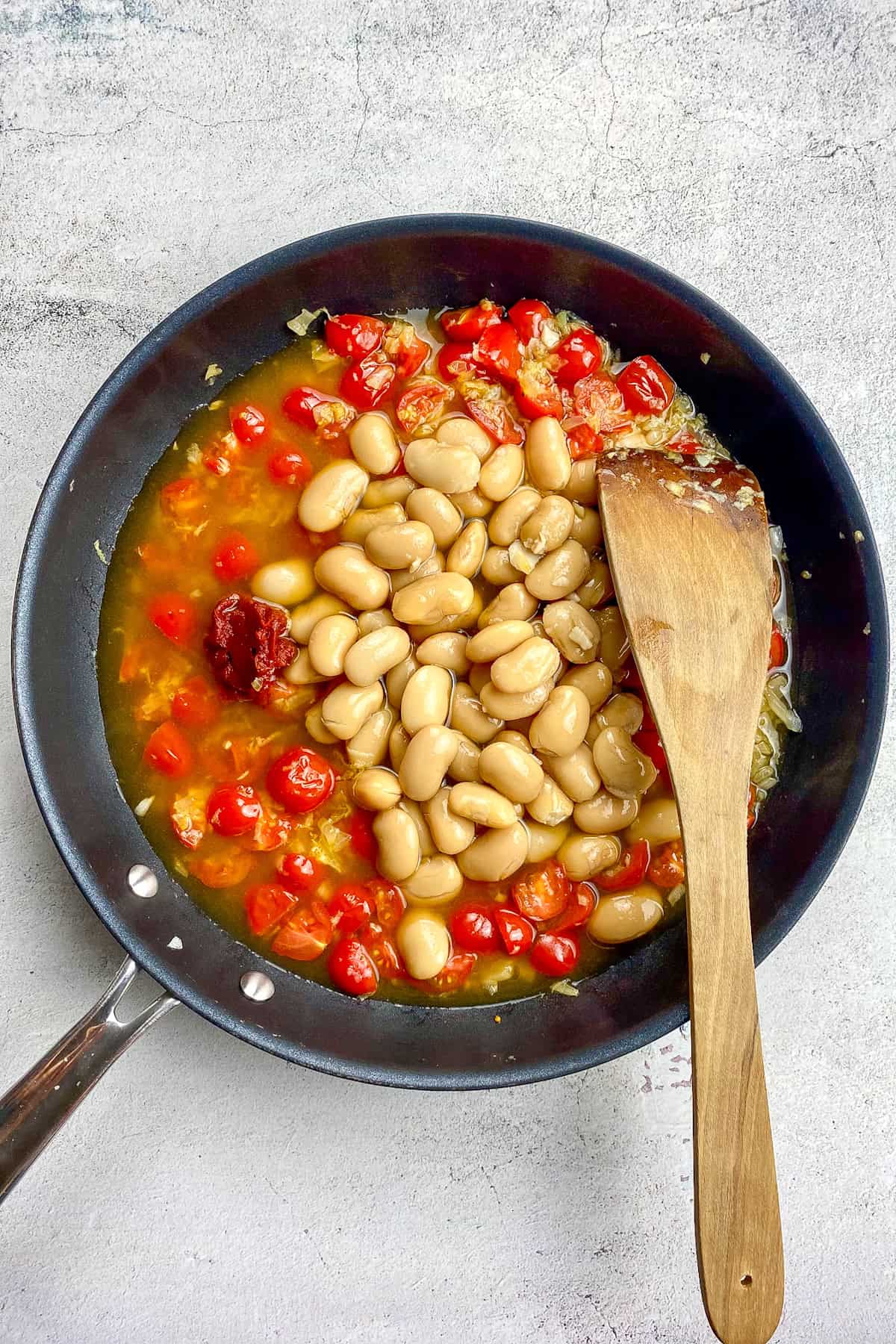 Tomato paste and broth added to the skillet.