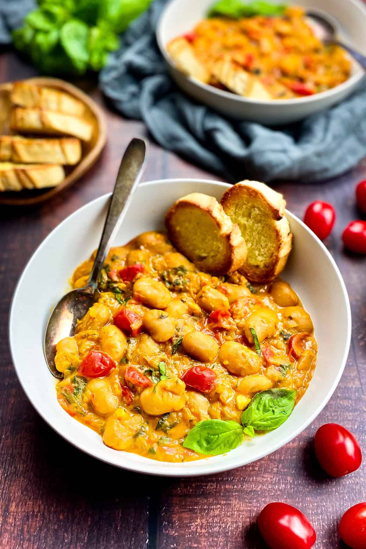 Vegan butter beans in a bowl with bread.