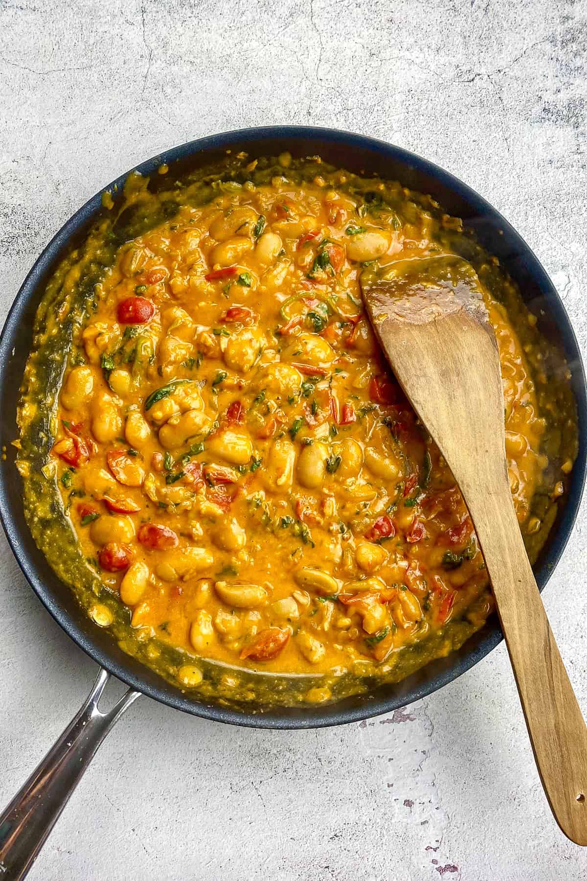 Vegan butter beans in a skillet.