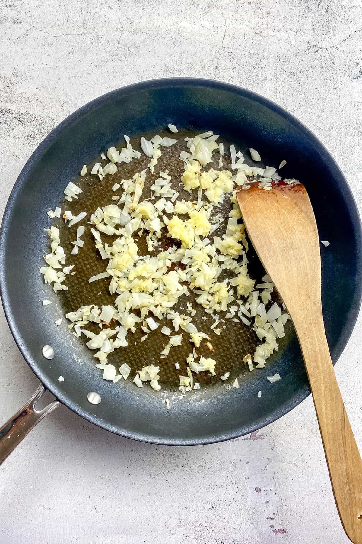 Onions and garlic cooked in a skillet.
