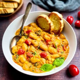 Vegan butter beans recipe in a bowl with bread.