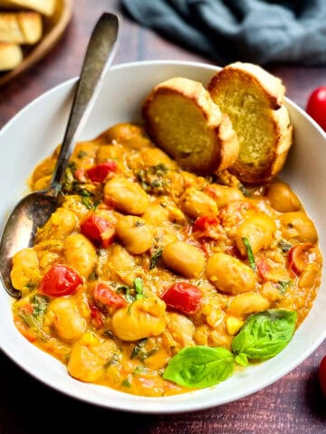Vegan butter beans recipe in a bowl with bread.