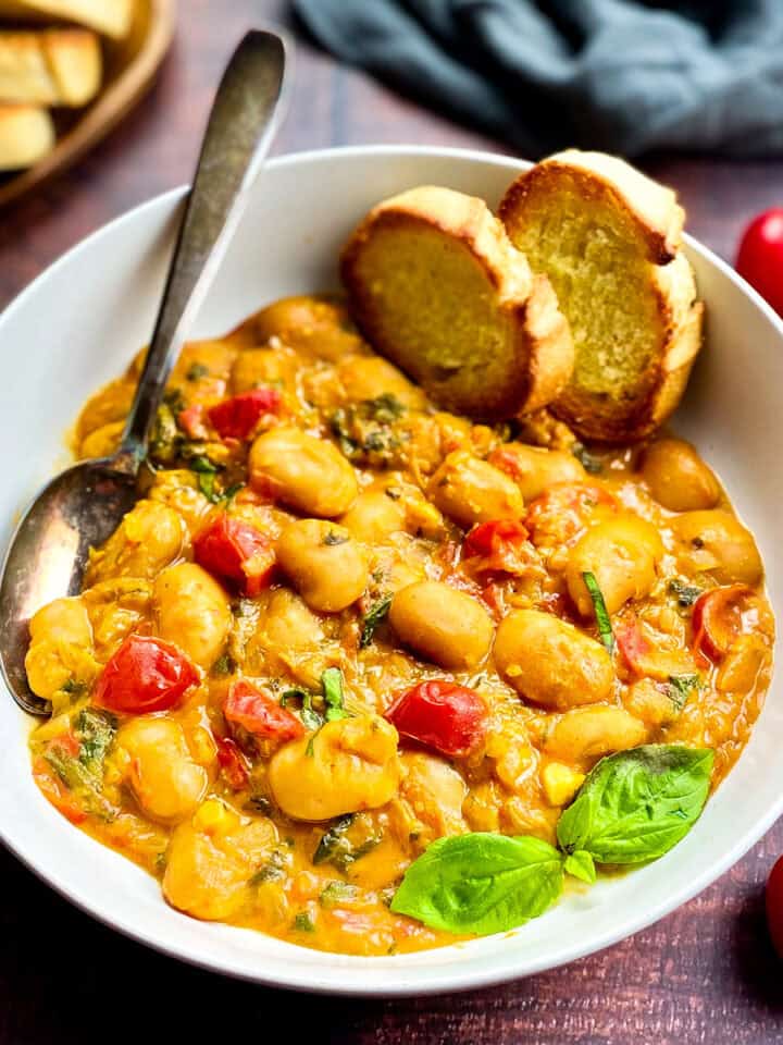 Vegan butter beans recipe in a bowl with bread.