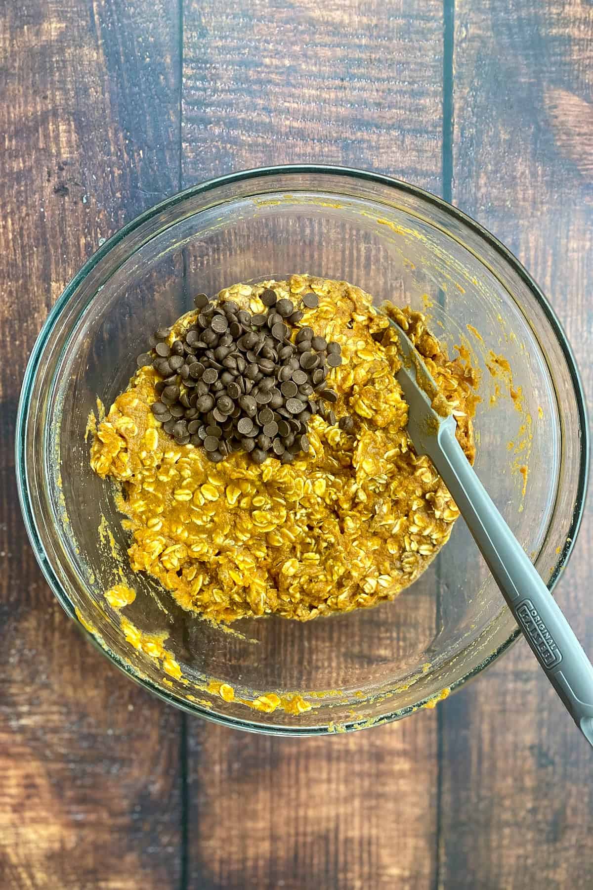 Chocolate chips added to pumpkin baked oatmeal batter.