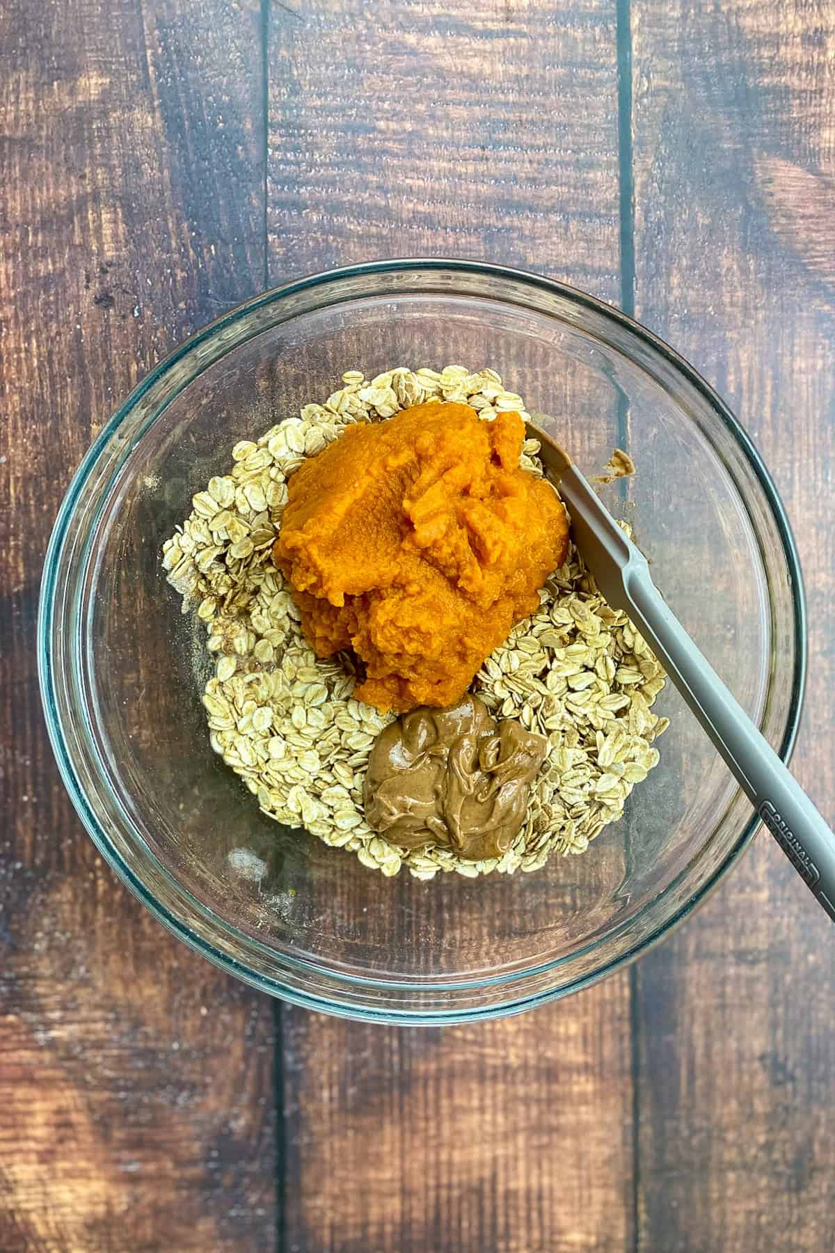 Pumpkin and other wet ingredients added to the bowl.