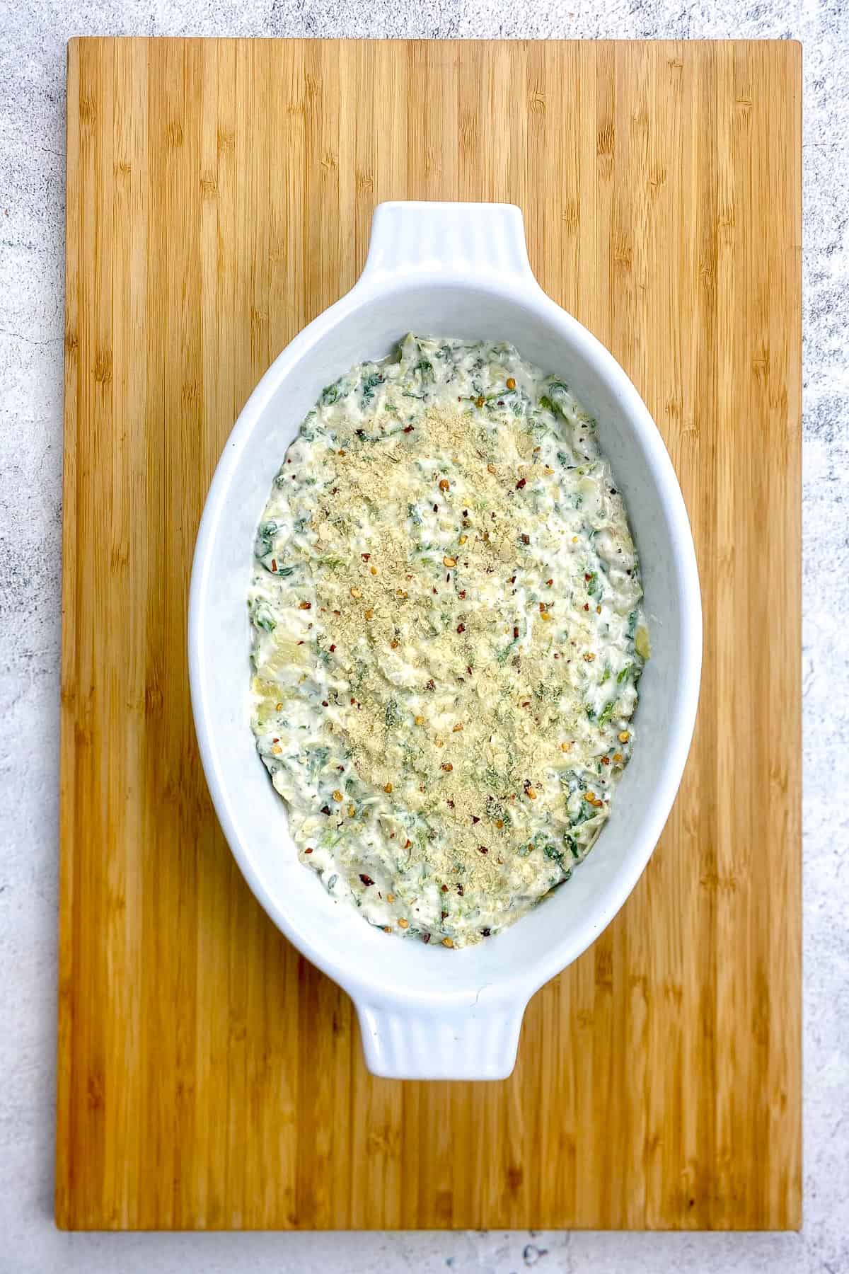 Spinach artichoke dip in a baking dish.